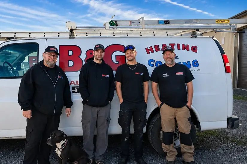 The real B & G Heating & Cooling crew — with shop dog — in front of their service van in Hamilton, Ontario
